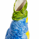 Vase en céramique avec perroquet bleu et jaune sur perchoir