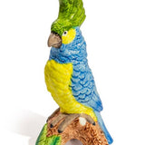Vase en céramique avec perroquet bleu et jaune sur perchoir