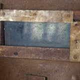An unusual antique welder's mask on a stand