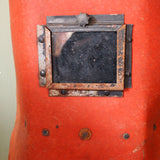 An unusual antique welder's mask on a stand