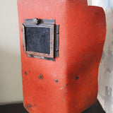 An unusual antique welder's mask on a stand