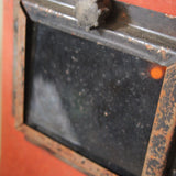 An unusual antique welder's mask on a stand