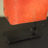 An unusual antique welder's mask on a stand