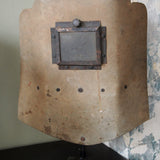 An unusual antique welder's mask on a stand