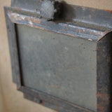 An unusual antique welder's mask on a stand