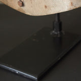 An unusual antique welder's mask on a stand