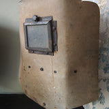 An unusual antique welder's mask on a stand