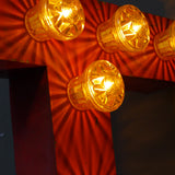 tres grande lettre T d'ancienne enseigne lumineuse façon fete foraine