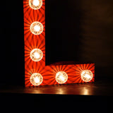 very large letter L from an old illuminated fairground sign