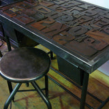 Industrial desk table with printed characters on top