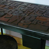 Industrial desk table with printed characters on top