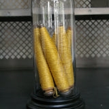 Globe decor of an old spindle and spool of thread