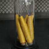 Globe decor of an old spindle and spool of thread