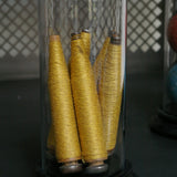 Globe decor of an old spindle and spool of thread