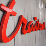 old zinc sign with the word "caterer" in bright red
