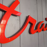 old zinc sign with the word "caterer" in bright red
