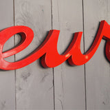 old zinc sign with the word "caterer" in bright red