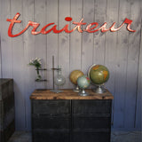 old zinc sign with the word "caterer" in bright red