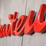 old zinc sign with the word "caterer" in bright red