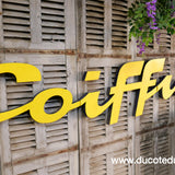 Former large metal hair salon sign