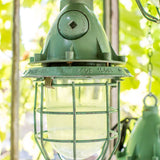 Green industrial pendant lamp with glass and grid