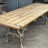 Industrial table with antique solid oak top and cast iron base with American patina