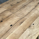 Industrial table with antique solid oak top and cast iron base with American patina