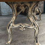 Industrial table with antique solid oak top and cast iron base with American patina